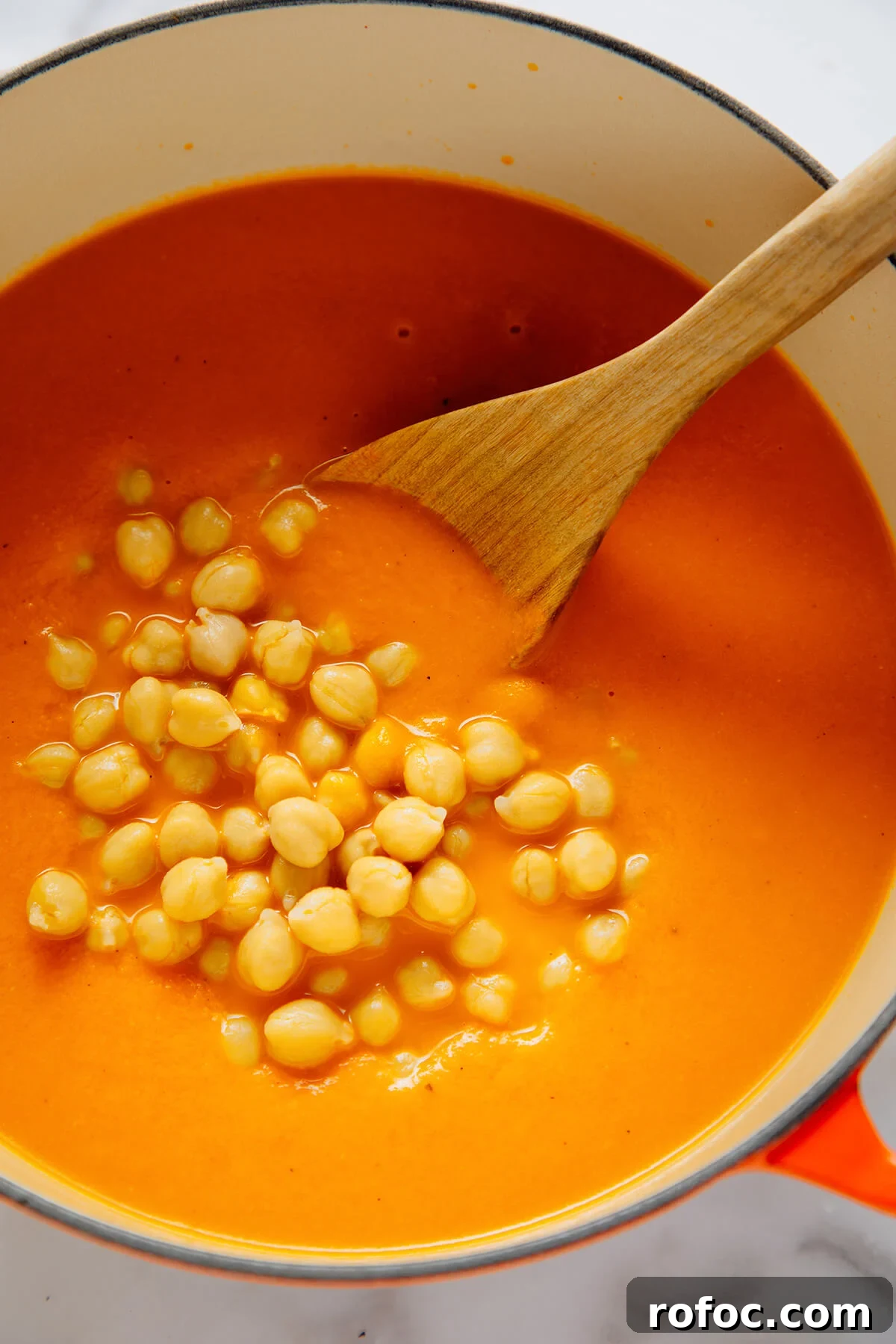 stirring chickpeas into soup