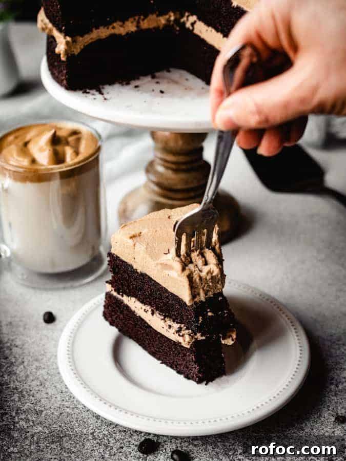 digging into a slice of dalgona coffee chocolate cake with a fork