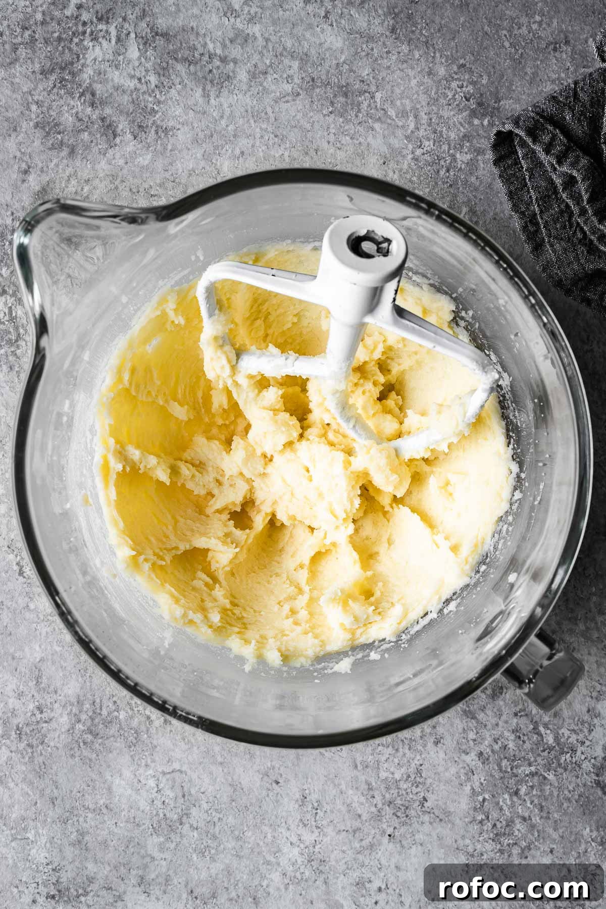 Creamed butter and sugar with eggs and vanilla in a mixing bowl.