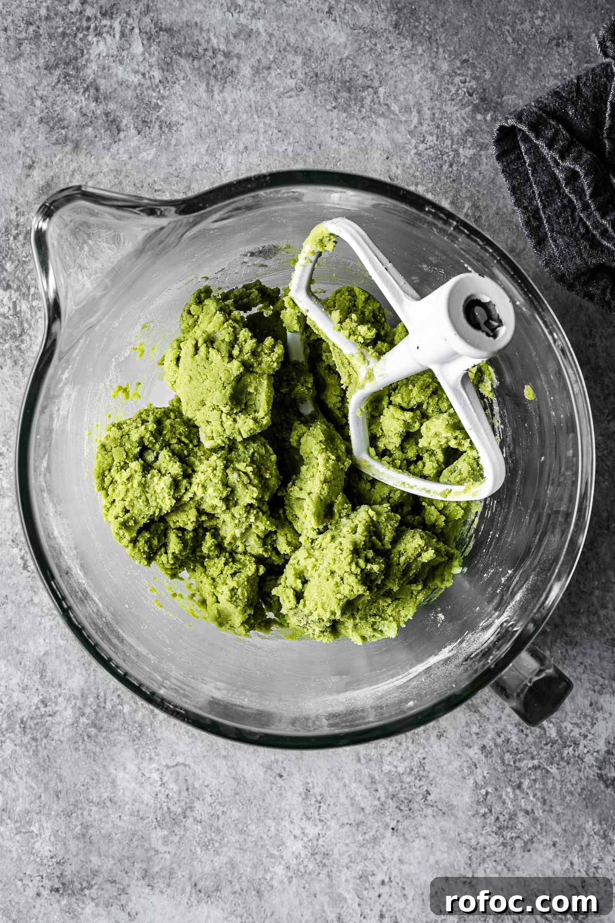 Green matcha cookie dough in a mixing bowl.