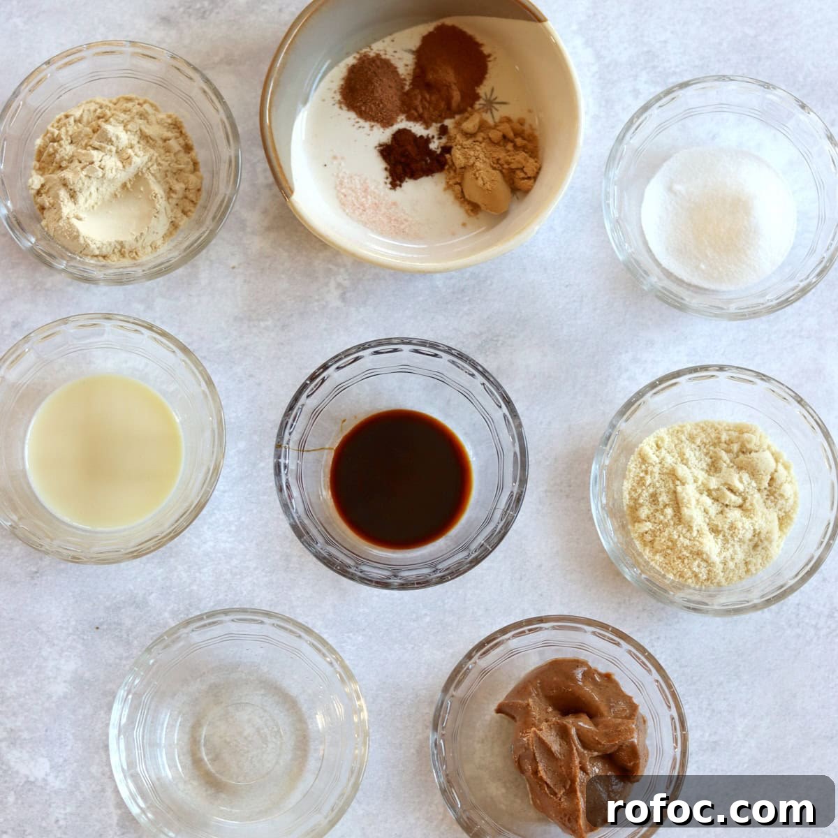 Ingredients needed to make no bake gingerbread protein bites on a white marble countertop.