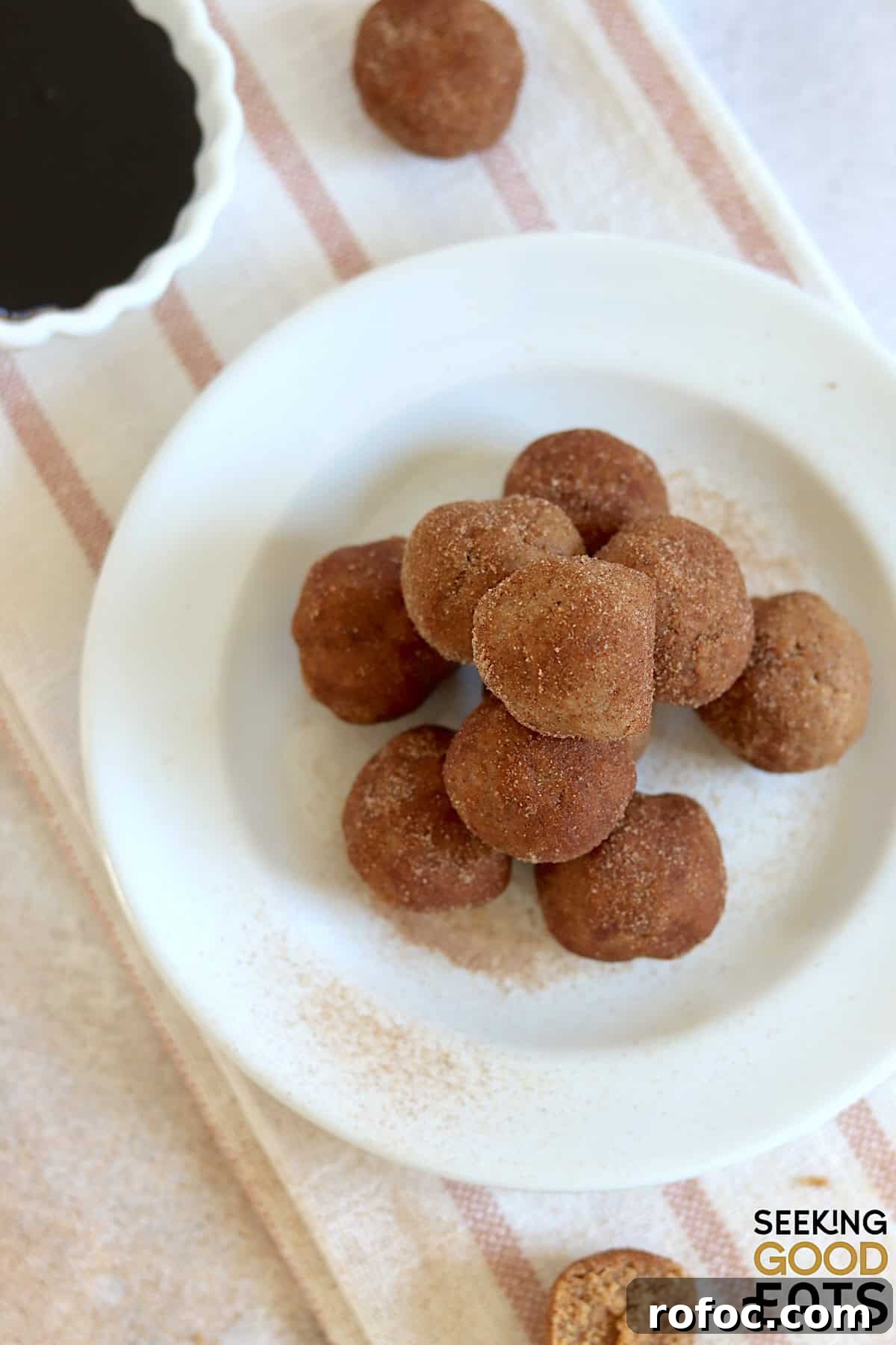 No bake gingerbread protein balls on a white round plate.