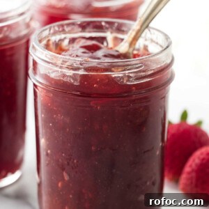 Fresh strawberry jam in a mason jar.