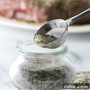 Spoon adds seasoned salt into jar.