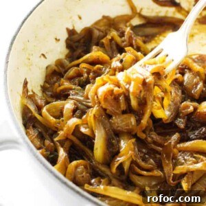 A fork picking up caramelized onions.