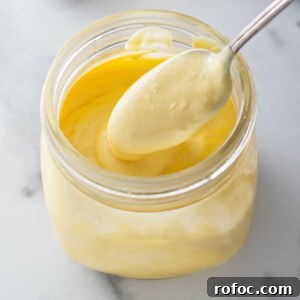 A jar filled with hollandaise sauce.