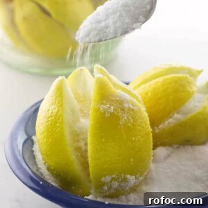 Pouring salt into lemon crevices.