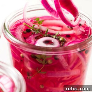 Pickled red onions in a jar.