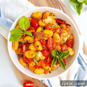 Crispy Sheet Pan Gnocchi with Roasted Vegetables 8 A bowl filled with gnocchi, vegetables, and basil.